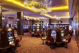 uang77 slot game lobby showing football betting, live casino, and slot games accessible via unified DANA-funded balance